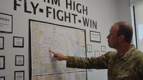 U.S. Air Force Tech Sgt. Payden Forkum points out some of the territory he serves on a map located in the recruitment office on North Westover Boulevard. (Photo Courtesy of Alan Mauldin)