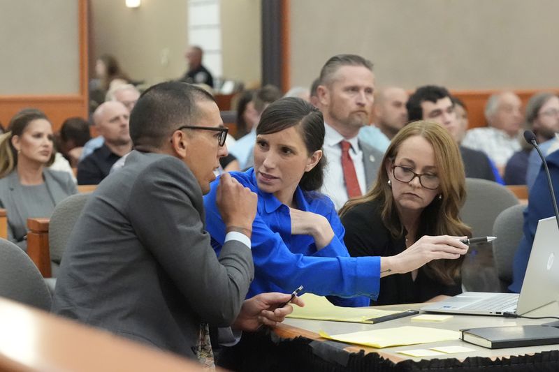 Kouri Richins, center, a Utah mother of three who wrote a children's book about coping with grief after her husband's death and was later accused of fatally poisoning him, looks on during a court hearing Tuesday, Aug. 27, 2024, in Park City, Utah. (AP Photo/Rick Bowmer, Pool)