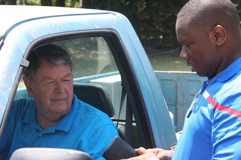 Maranatha Baptist Church pastor Tony Lowden chats with Plains Mayor L.E. "Boze" Godwin III, who was riding around town in his pickup truck.