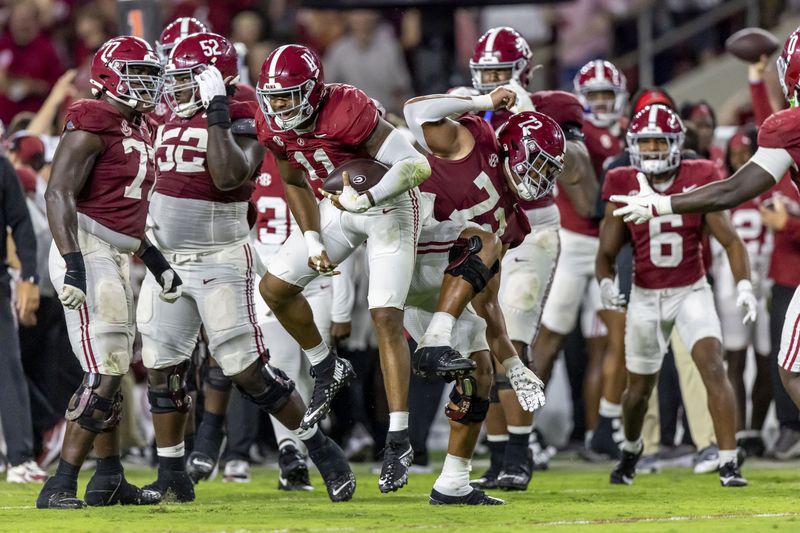 Alabama linebacker Jihaad Campbell and offensive lineman Parker Brailsford celebrates after Campbell's interception during the first half of an NCAA college football game against Georgia, Saturday, Sept. 28, 2024, in Tuscaloosa, Ala. (AP Photo/Vasha Hunt)