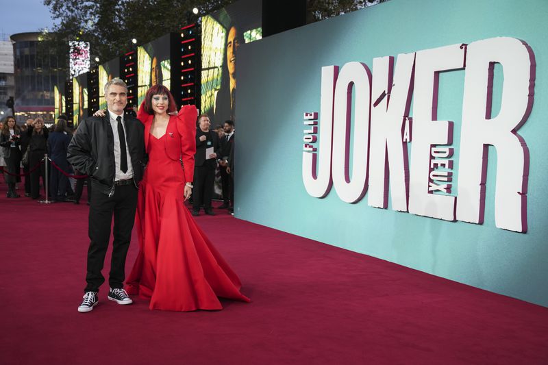 Joaquin Phoenix, left, and Lady Gaga pose for photographers upon arrival at the premiere for the film 'Joker: Folie A Deux' on Wednesday, Sept. 25, 2024, in London. (Photo by Scott A Garfitt/Invision/AP)