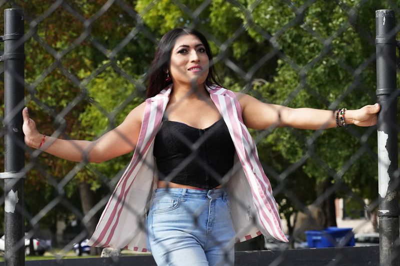 Julieth Luna Garcia, a transgender woman from El Salvador, poses for photos at Horner Park in Chicago, Monday, Sept. 30, 2024. (AP Photo/Nam Y. Huh)