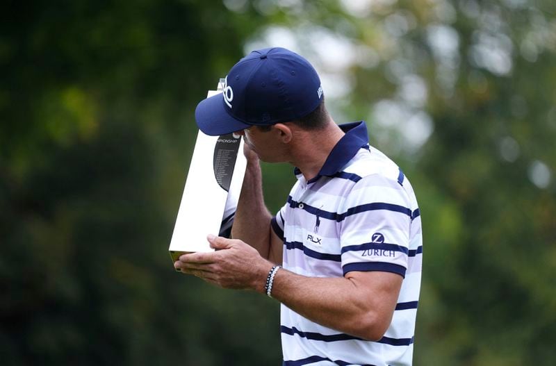 Billy Horschel of the U.S. kisses the trophy following day four of the PGA Championship at Wentworth Golf Club in Virginia Water, England, Sunday Sept. 22, 2024. (Zac Goodwin/PA via AP)