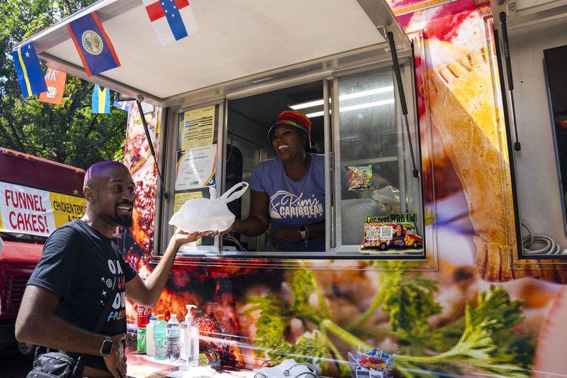 Kim's Caribbean Kitchen sells food at the Pure Heat Community Festival in Piedmont Park on Sunday, Sept. 1, 2024. (Olivia Bowdoin for the AJC). 