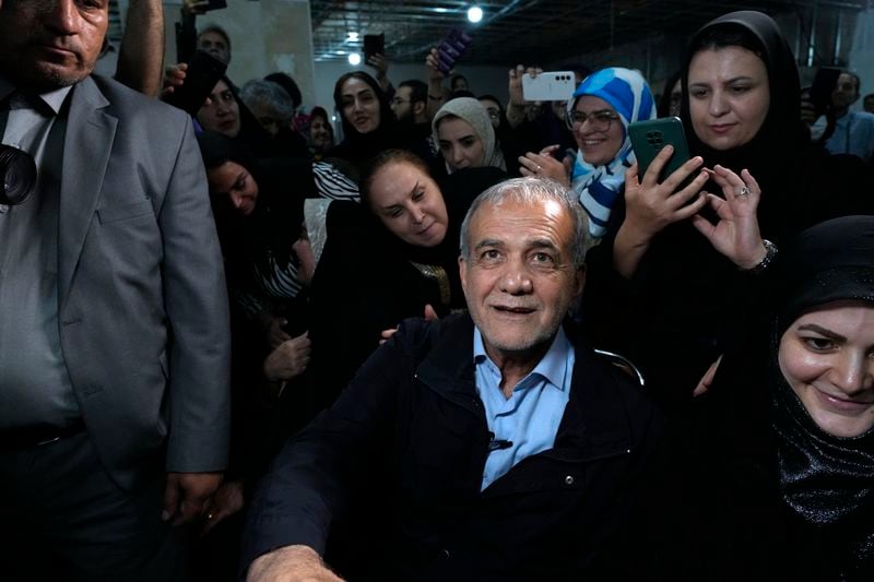 Reformist candidate for Iran's June 28, presidential election Masoud Pezeshkian is surrounded by his supporters, during a campaign rally in Tehran, Iran, Friday, June 14, 2024. (AP Photo/Vahid Salemi)