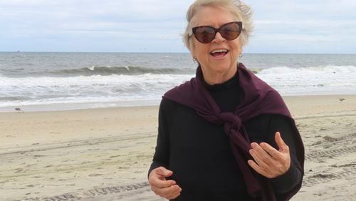 Kimberly Paterson, a leader of a group opposed to a project to bring an offshore wind power cable onshore in her community, speaks, Sept. 30, 2024, on a beach in Sea Girt, N.J., where the cable is projected to come ashore. (AP Photo/Wayne Parry)