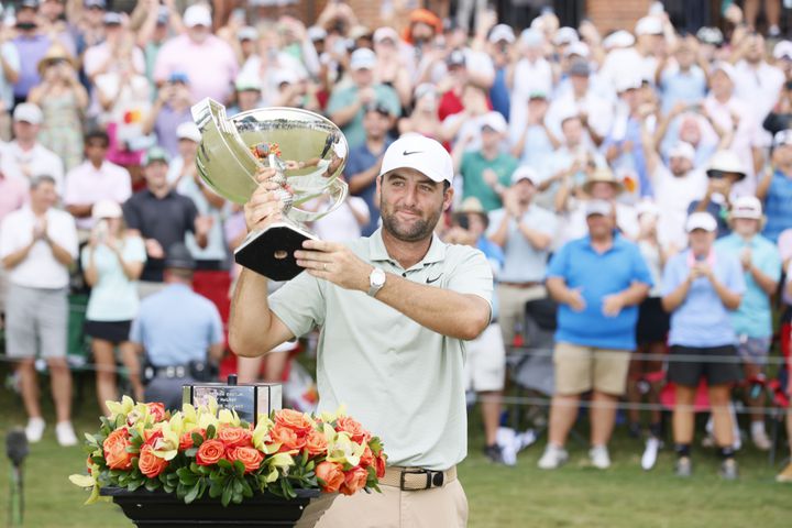 Scottie Scheffle celebrates with the FedEx Cup trophy after winning the Tour Championship at East Lake Golf Club, Sunday, Sept. 1, 2023, in Atlanta. 
(Miguel Martinez / AJC)