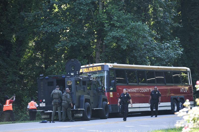 A Gwinnett County, Ga. commuter bus sits in the road where it was stopped in Smoke Rise, Ga., on Tuesday, June 11, 2024. Atlanta police say the transit bus fled from officers responding to a dispute on board, leading them on a wild and lengthty chase into a neighboring county before it was stopped. (AP Photo/Ben Gray)