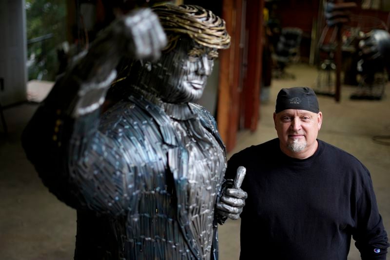 Artist Bill Secunda posses for a photograph with his sculpture of Republican presidential nominee former President Donald Trump, in Butler, Thursday, Sept. 26, 2024. (AP Photo/Matt Rourke)