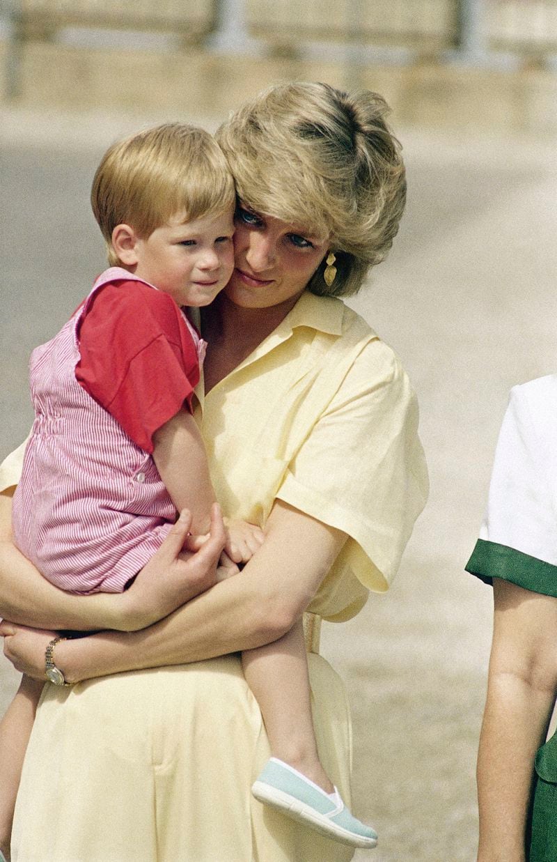 FILE - The Princess of Wales holds son Prince Harry while royal families posed for photographers at the Royal Palace, Mallorca, Spain, Aug. 9, 1987. (AP Photo/John Redman, File)