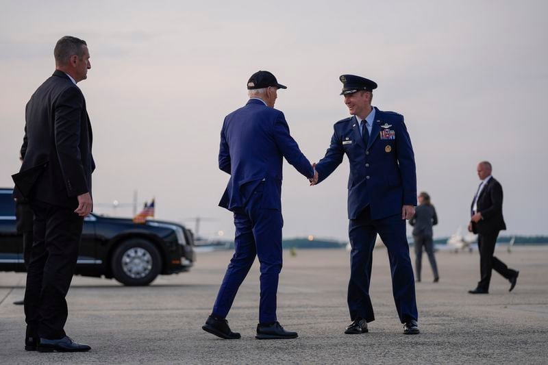 President Joe Biden is greeted by Col. Gregory Adams, Commander of the 89th Operations Group, as he arrives to board Air Force One for a trip to France to mark the 80th anniversary of D-Day, Tuesday, June 4, 2024, in Andrews Air Force Base, Md. (AP Photo/Evan Vucci)