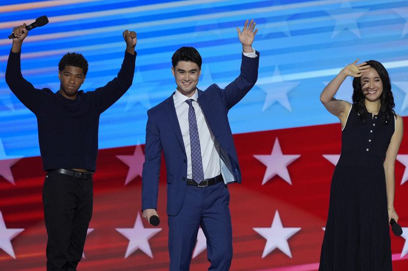 Alexander Hudlin, from left, Jasper Emhoff and Arden Emhoff wave after speaking during the Democratic National Convention Wednesday, Aug. 21, 2024, in Chicago. (AP Photo/J. Scott Applewhite)