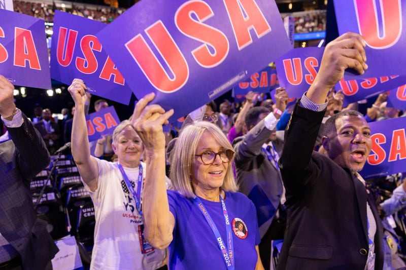 Georgia delegates wave USA signs on the first day of the Democratic National Convention in Chicago on Monday.