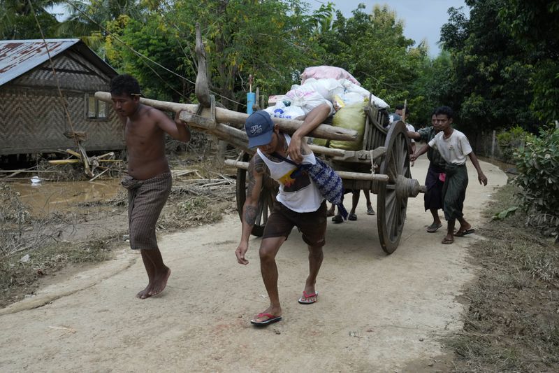 Local residents carry food on their cart, in Naypyitaw, Myanmar, Tuesday, Sept. 17, 2024. (AP Photo/Aung Shine Oo)