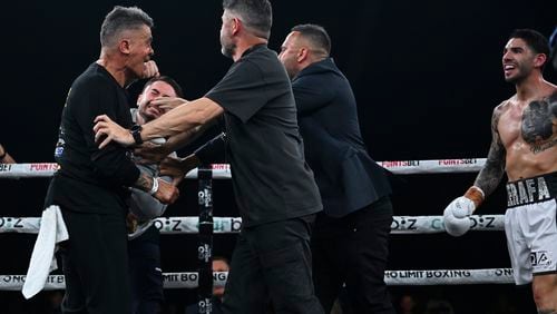 Jason-Manuel Zerafa, second left, appears to punch trainer Tommy Mercuri following a bout in Sydney, Wednesday, Aug. 28, 2024, between Zerafa's brother Michael Zerafa and Mercury's fighter Tommy Browne. (Grant Trouville/No Limit Boxing via AP)