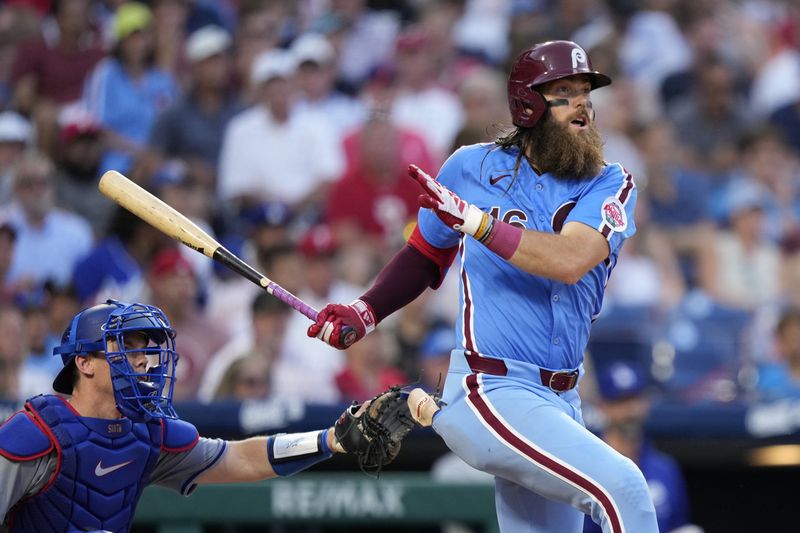 Philadelphia Phillies' Brandon Marsh follows through after hitting a run-scoring triple against Los Angeles Dodgers pitcher Landon Knack during the sixth inning of a baseball game, Thursday, July 11, 2024, in Philadelphia. (AP Photo/Matt Slocum)