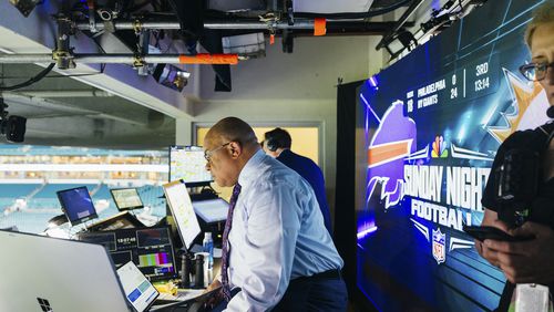 Sports commentator Mike Tirico rehearses in the broadcast booth during the Miami Dolphins vs. Buffalo Bills NFL game at Hard Rock Stadium in Miami Gardens, Fla. on Jan. 7, 2024. Alfonso Duran/The New York Times)