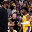 Los Angeles Lakers' LeBron James, left, greets his son, Bronny James as Bronny comes off the court during the first half of a preseason NBA basketball game, Friday, Oct. 4, 2024, in Palm Desert, Calif. (AP Photo/Mark J. Terrill)