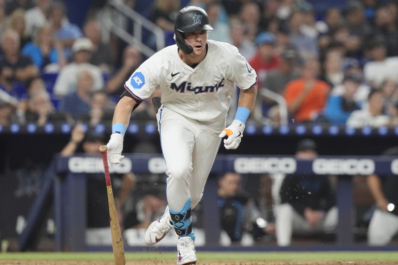 Miami Marlins' Kyle Stowers hits a triple to right field during the fourth inning of a baseball game against the Los Angeles Dodgers, Tuesday, Sept. 17, 2024, in Miami. (AP Photo/Marta Lavandier)