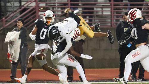 Colquitt County wide receiver Ny Carr (5) makes a catch against Milton defensive back Tristan Lester (12) but loses possession of the ball during the second half in the 7A quarterfinals at Milton High School Friday, November 24, 2023, in Milton, Ga. Carr lost possession of the ball on a hit by Lester but Lester was penalized on the play. Milton won 39-37 to advance to the semifinals. (Jason Getz / Jason.Getz@ajc.com)