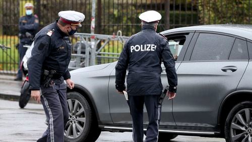 FILE - Police officers check a car in downtown Vienna, Austria, Friday, Oct. 30, 2020. (AP Photo/Ronald Zak, File)