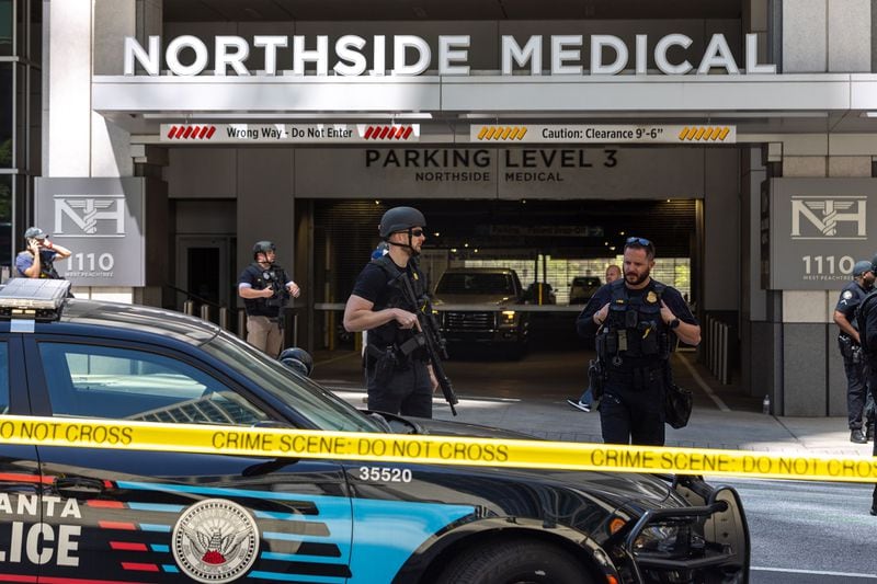 Law enforcement officers are seen on West Peachtree Street in front of Northside Hospital Midtown medical office building, where five people were shot on Wednesday, May 3, 2023. (Arvin Temkar/The Atlanta Journal-Constitution/TNS)