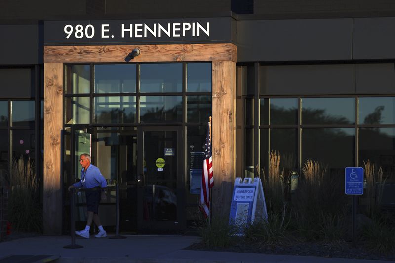 Election staff set up at the City of Minneapolis early voting center on the first day of early voting, Friday, September 20, 2024, in Minneapolis, Minn. (AP Photo/Adam Bettcher)