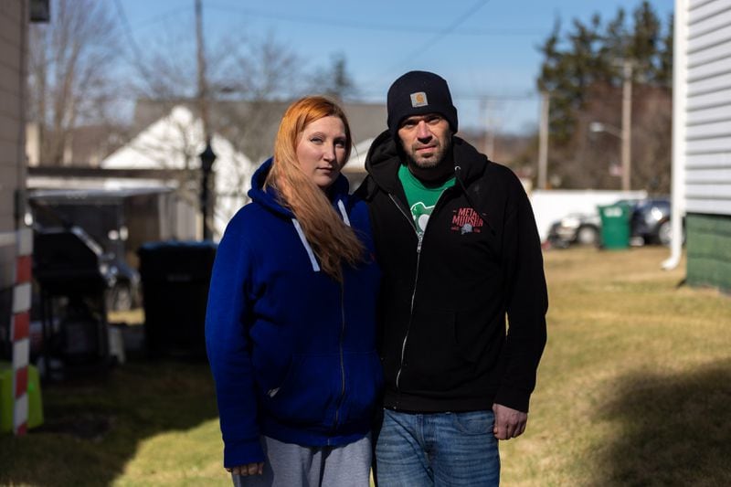 Ashley McCollum and Matt McAnlis pose for a portrait in beside their home near the Norfolk Southern accident site in East Palestine, Ohio on Saturday, February 18, 2023. (Arvin Temkar / arvin.temkar@ajc.com)