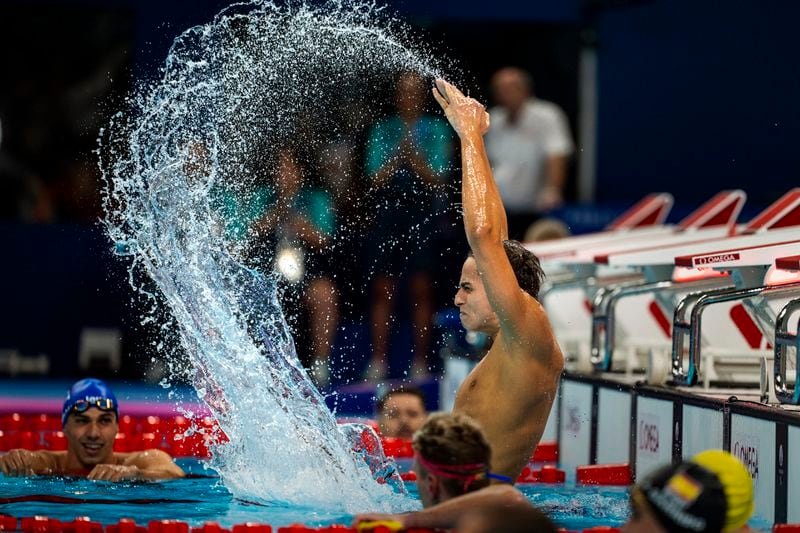 Paralympic athlete Ugo Didier, of France, celebrates by hitting the water after winning the Men's 400 Freestyle -S9, during the 2024 Paralympics, Thursday, Aug. 29, 2024, in Paris, France. (AP Photo/Emilio Morenatti)