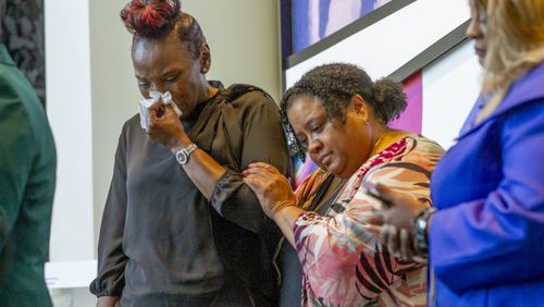 Wanda Cooper-Jones (L), the mother of the late Ahmaud Arbery, becomes emotional during an event in honor of her son at the National Center for Civil and Human Rights Wednesday, February 23, 2022.   STEVE SCHAEFER FOR THE ATLANTA JOURNAL-CONSTITUTION