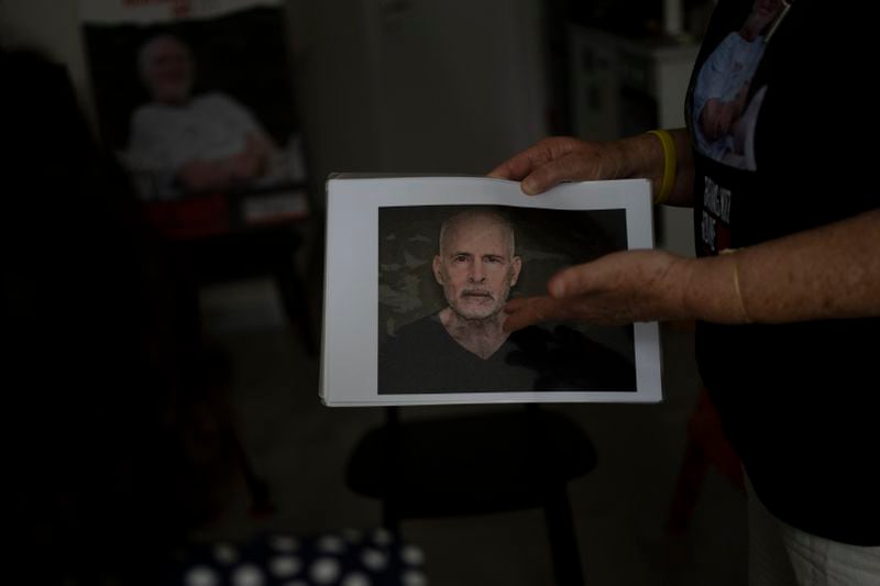 Aviva Siegel, who was held hostage by Hamas in the Gaza Strip for 51 days after she was kidnapped with her husband on Oct. 7, shows a militant video still of her husband, Keith, who is still in captivity, in Tel Aviv, Israel, Sunday, Sept. 29, 2024. (AP Photo/Maya Alleruzzo)