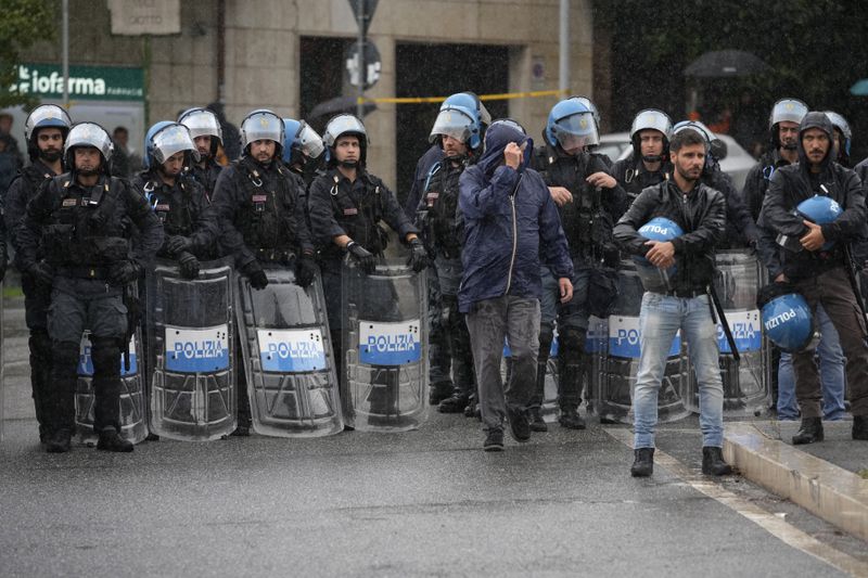 Italian Police officers patrol during a protest in Rome, Saturday, Oct. 5, 2024. Pro-palestinians people take to the street in an unauthorised march in the centre of Rome two days ahead of the first anniversary of the Oct. 7. (AP Photo/Andrew Medichini)