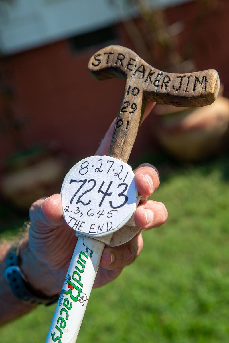 Jim Merritt, 73, of Buford, holds the what stick he took with him on his runs. It commemorates his 7,243-day running streak. PHIL SKINNER FOR THE ATLANTA JOURNAL-CONSTITUTION.