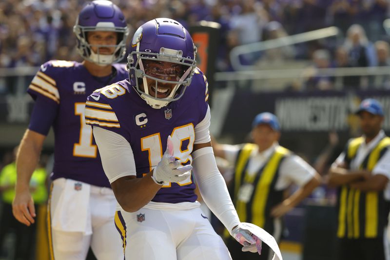 Minnesota Vikings wide receiver Justin Jefferson (18) celebrates after catching a touchdown pass during the first half of an NFL football game against the Houston Texans, Sunday, Sept. 22, 2024, in Minneapolis. (AP Photo/Bruce Kluckhohn)