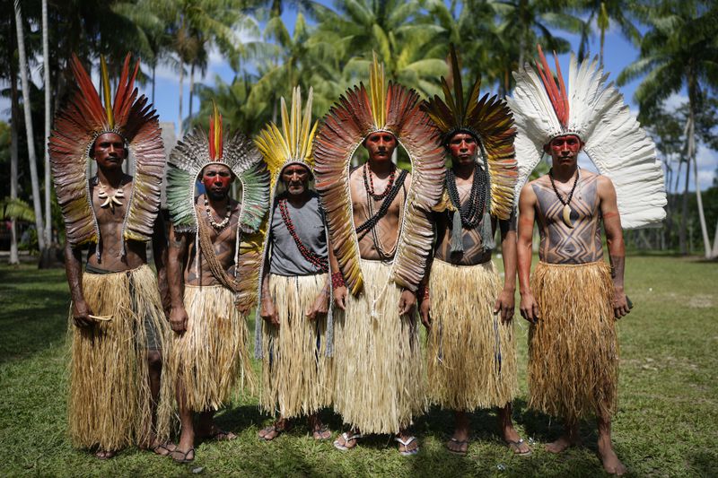 Apolima-Arara Indigenous men pose for a picture during the annual celebration recognizing the Ashaninka territory in the Apiwtxa village, Acre state, Brazil, Monday, June 24, 2024. (AP Photo/Jorge Saenz)