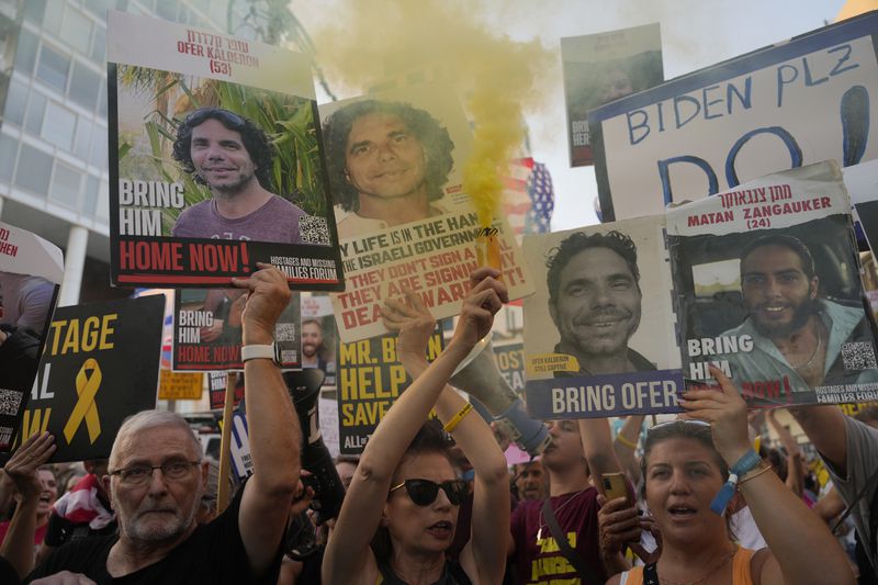 Relatives of hostages held by Hamas in the Gaza Strip and their supporters protest near the hotel where U.S. Secretary of State Antony Blinken is staying during his visit in Tel Aviv, Monday, Aug. 19, 2024. (AP Photo/Ohad Zwigenberg)