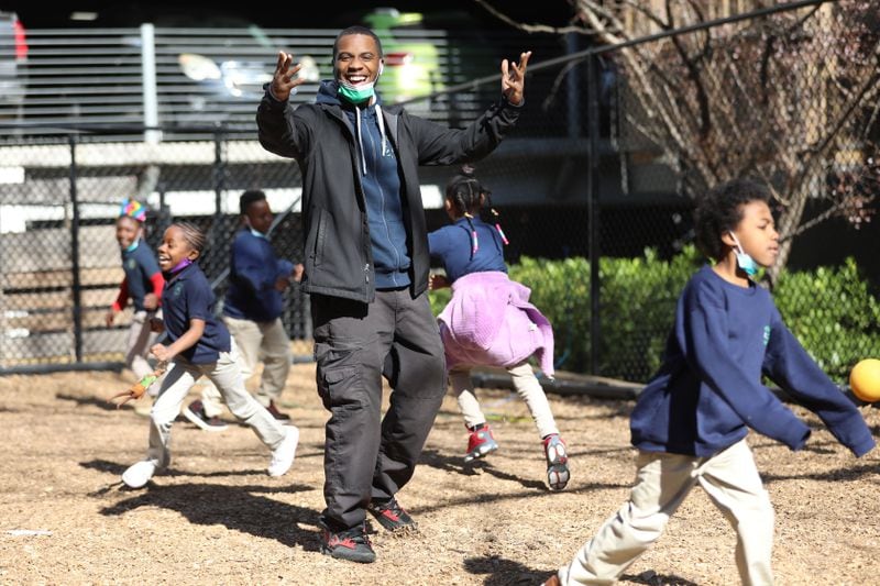Will Armstrong, a security officer at Boyce L. Ansley School, interacts with students during recess. (Miguel Martinez for The Atlanta Journal-Constitution)