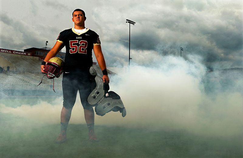 072114 HOSCHTON: Offensive lineman Kaleb Kim poses for a portrait on the football field at Mill Creek High School on Monday, July 21, 2014, in Bogart. CURTIS COMPTON / CCOMPTON@AJC.COM Mill Creek offensive lineman Kaleb Kim