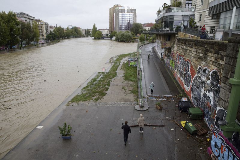 The Donaukanal channel floods its banks in central Vienna, Austria, Sunday, Sept. 15, 2024. (AP Photo/Heinz-Peter Bader)