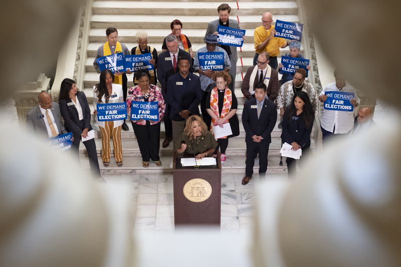 U.S. Rep. Lucy McBath, D-Marietta, calls for the governor to remove three members of the State Election Board during a news conference at the Capitol in Atlanta on Monday.