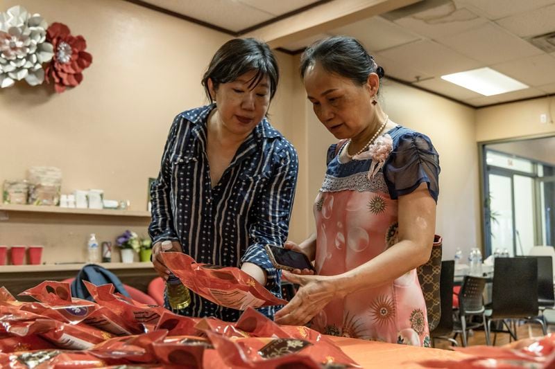 Nevada Chinese Association President Jenny Koo (left) sorts packages of zongzi, a rice dish wrapped in bamboo leaves, with Las Vegas resident Sheli Lu during the Dragon Boat Festival in Las Vegas, on Wednesday, June 5, 2024. (Photo by Christopher Lomahquahu/News21)