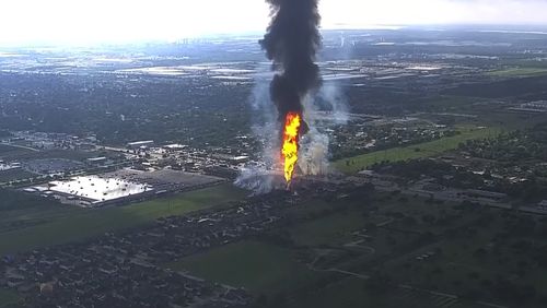 A pipeline fire in La Porte, Texas, sparks grass fires and burns power poles on Monday, Sept. 16, 2024, forcing people in the surrounding neighborhood to evacuate. (KTRK via AP)