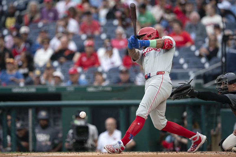 Philadelphia Phillies shortstop Edmundo Sosa hits the ball during the second inning of a baseball game against the Washington Nationals, Sunday, Sept. 29, 2024, in Washington. (AP Photo/Jose Luis Magana)