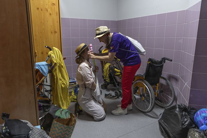 Vladyslava Kulinich, right, Tetiana Nosova, who have the clown names Lala and Zhuzha, prepare to perform at Okhmatdyt children's hospital in Kyiv, Ukraine, Thursday Sept. 19, 2024. (AP Photo/Anton Shtuka)