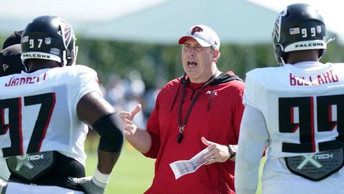 Falcons head coach Arthur Smith talks to defensive lineman Grady Jarrett (97) and Jonathan Bullard (99) during a joint practice, Thursday, Aug. 19, 2021, in Miami Gardens, Fla. (Marta Lavandier/AP)