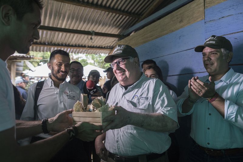 FILE - Howard Buffett receives presents during a visit with Colombia's President Ivan Duque, right, at a cocoa farm on Jan. 29, 2020 in La Gabarra, Colombia. (AP Photo/Ivan Valencia, File)