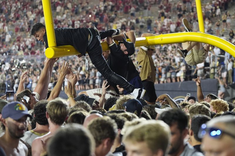 Vanderbilt fans tear down the goal post after the team's 40-35 win against Alabama after an NCAA college football game Saturday, Oct. 5, 2024, in Nashville, Tenn. (AP Photo/George Walker IV)