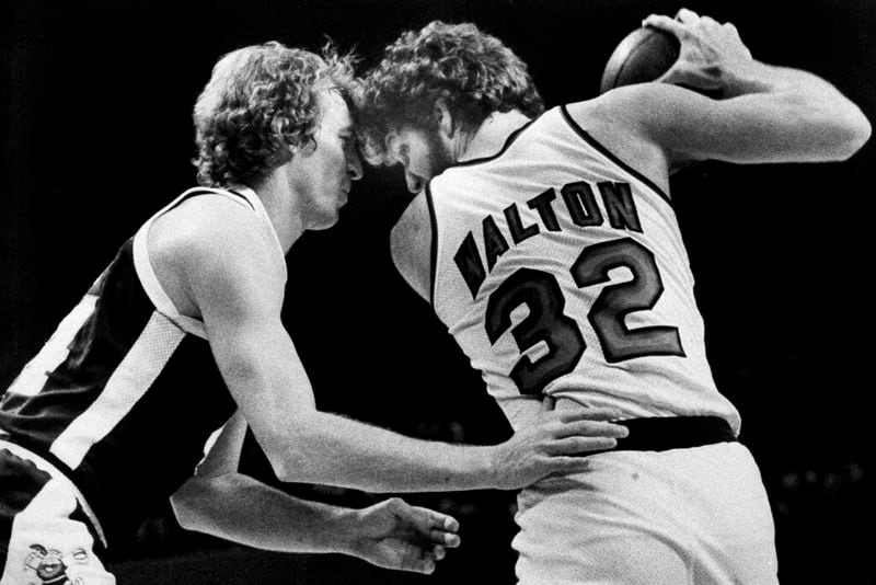FILE - Denver Nuggets' Dan Issel, left, guards Portland Trail Blazers' Bill Walton as Walton moves towards the basket during their game in Portland, Ore., Feb. 12, 1978. (AP Photo/Jack Smith, File)