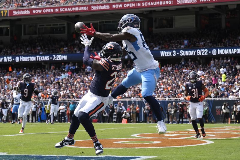 Tennessee Titans tight end Chigoziem Okonkwo catches a touchdown pass over Chicago Bears cornerback Tyrique Stevenson from quarterback Will Levis, during the first half of an NFL football game Sunday, Sept. 8, 2024, in Chicago. (AP Photo/Erin Hooley)