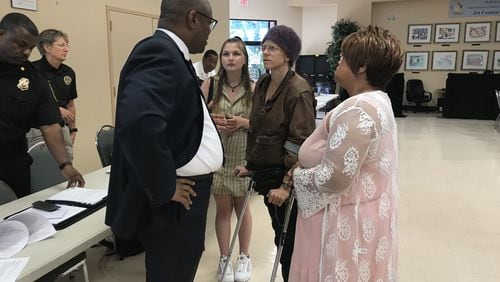 Zach Williams (far left), DeKalb County’s chief operating officer, speaks to advocates who complained about conditions at the jail during a county commission meeting on April 23, 2019. TIA MITCHELL/TIA.MITCHELL@AJC.COM